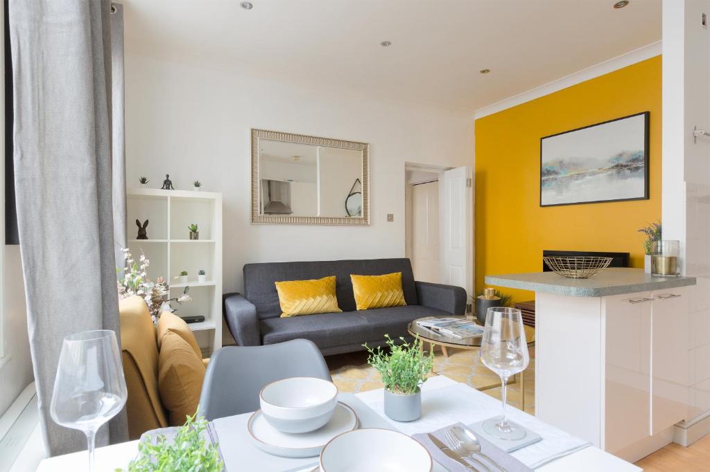 a living room with a couch and a table at The Aldgate Flat in London