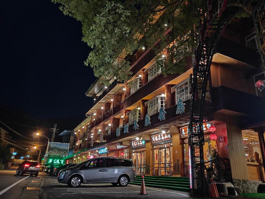 a car parked in front of a building at night at Kingtaiwan Hotel in Lugu Lake