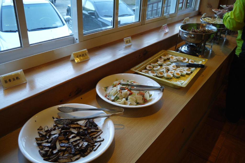 a counter with two plates of food on a table at Kingtaiwan Hotel in Lugu Lake