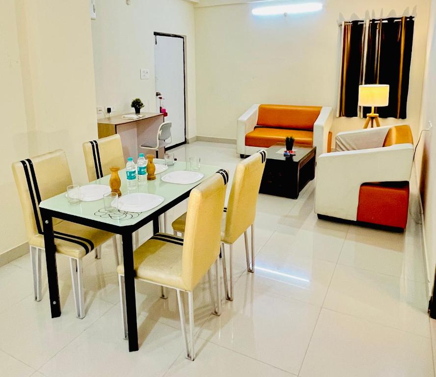 a dining room with a table and chairs in a room at HOTEL NAMAHA in Shamshabad