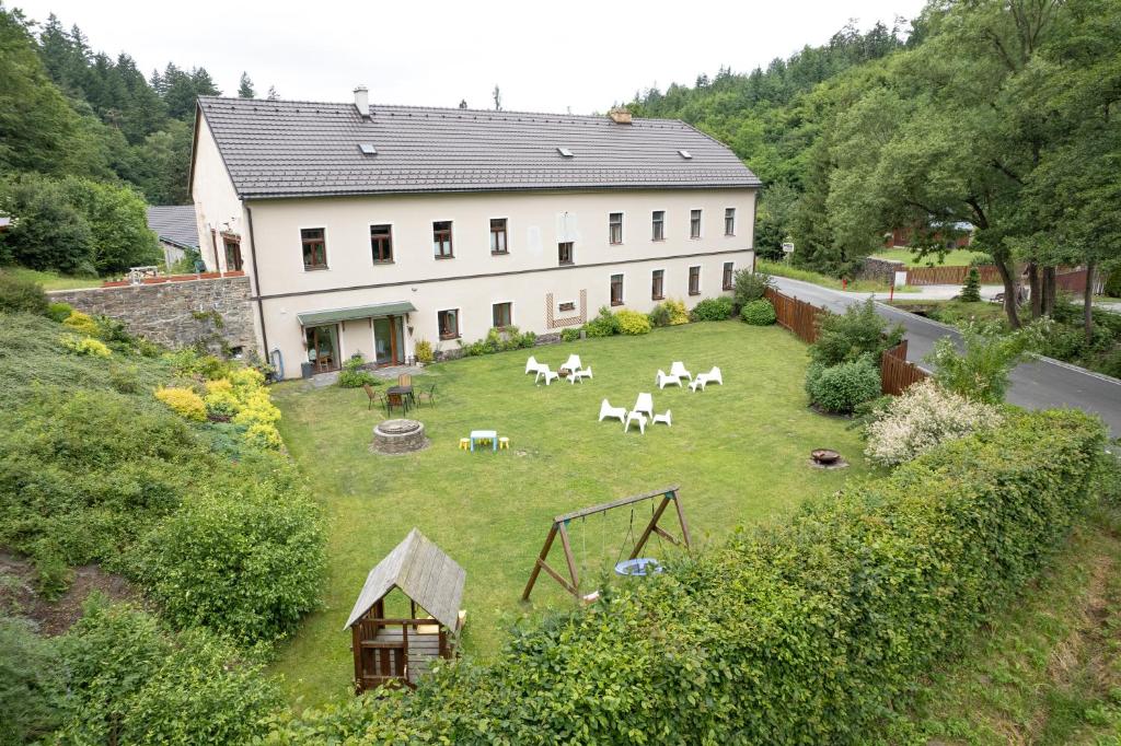 an aerial view of a house with horses in the yard at Penzion Starý Pivovar in Křtiny