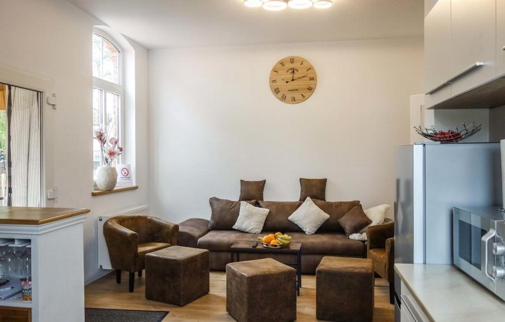 sala de estar con sofá y reloj en la pared en Zur Ziegenmühle, en Lehrte