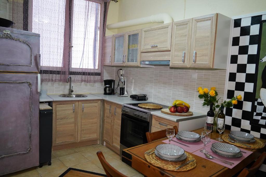 a kitchen with wooden cabinets and a table with fruits on it at ΩκεανιςHouse 1 in Preveza