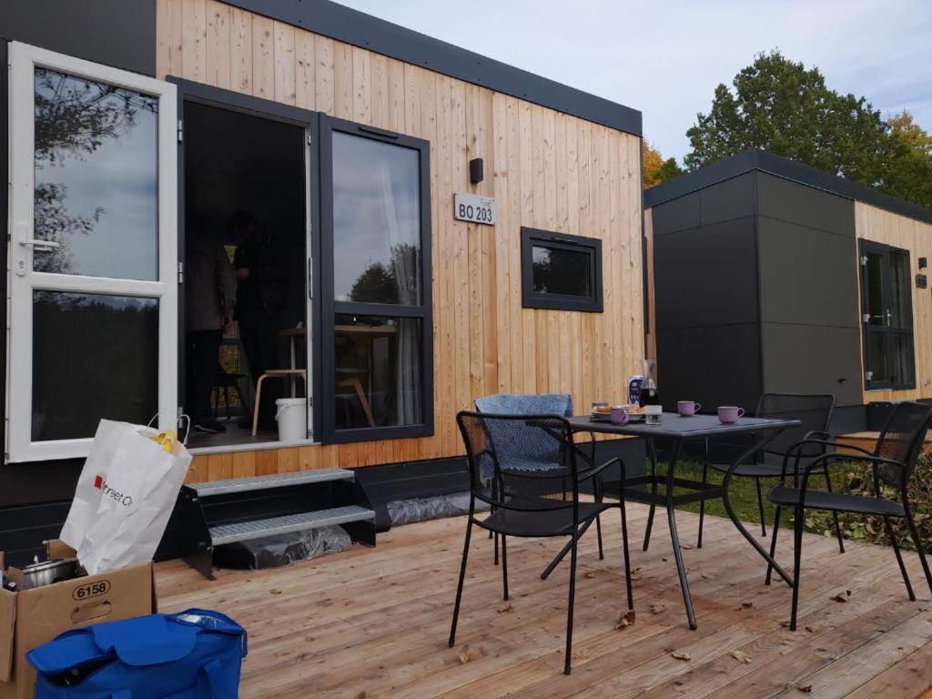 a patio with a table and chairs and a building at Tinyhouse Wemding in Wemding