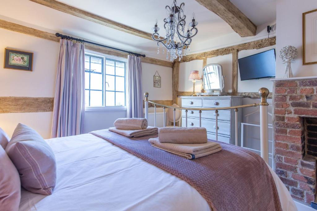 a bedroom with a bed and a fireplace at Charlie's Cottage in Ludlow