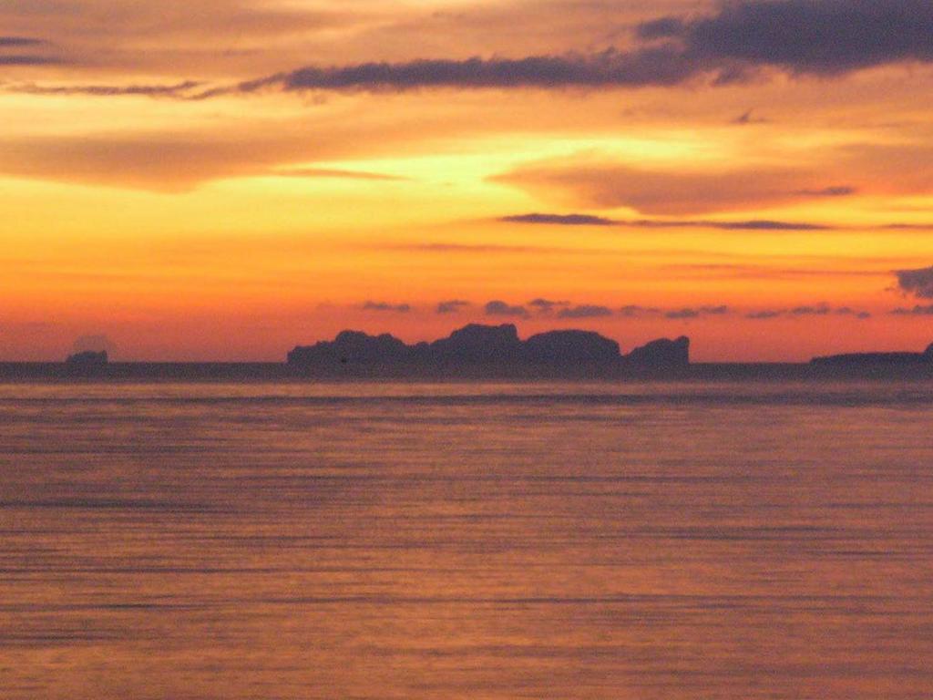 a sunset over a body of water with the ocean at Room in Bungalow - Foresta Cottage of Koh Pu no6197 in Ko Jum
