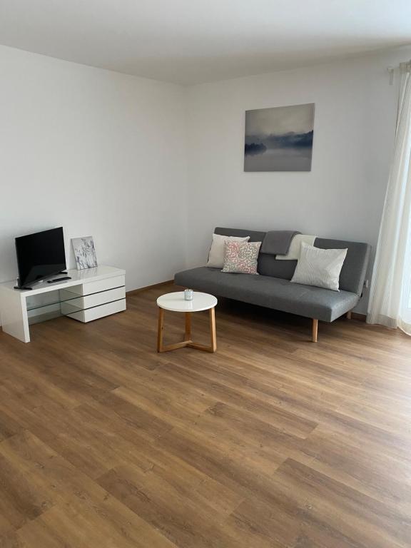 a living room with a couch and a table at Ferienwohnung Landhege in Michelfeld