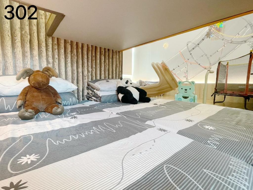 Postel nebo postele na pokoji v ubytování Wind Natural Parent-child Inn
