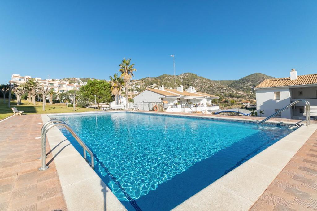 a swimming pool with blue water in a house at Romantic: Precioso frente al mar in Sitges