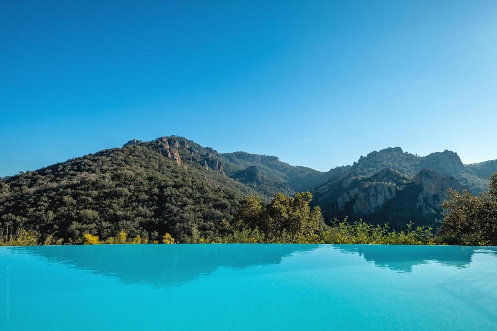 een blauw meer met bergen op de achtergrond bij Villa Baladou in Fréjus