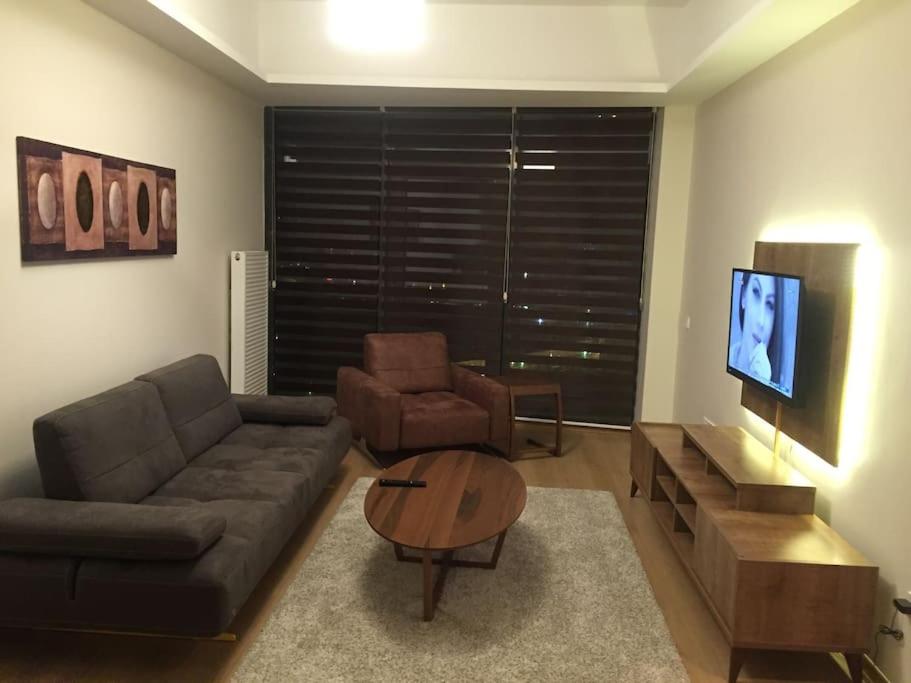 a living room with a couch and a table at Atasehir rezidans kendi eviniz gibi rahat in Istanbul