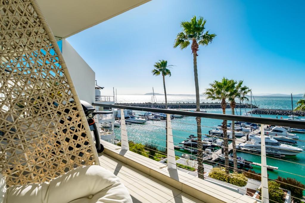 a room with a balcony with a view of a marina at Aqua Views in Cape Town