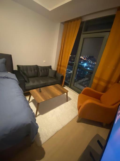 a room with a bed and a couch and a window at Atasehir rezidans in Istanbul