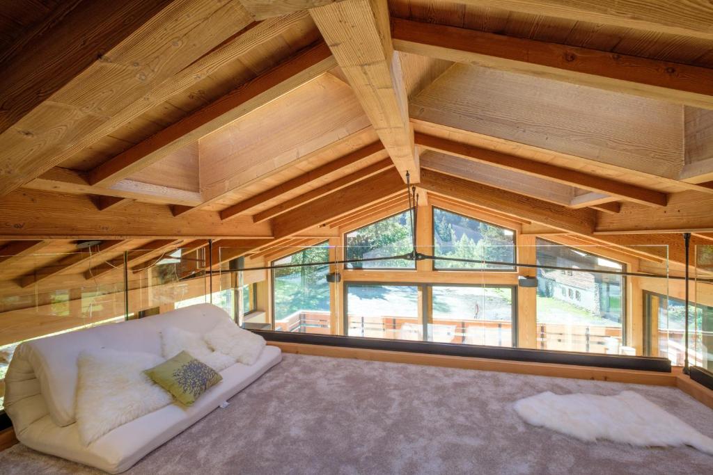 een kamer met een witte bank in een kamer met ramen bij Chalet Aikoa in Chamonix-Mont-Blanc