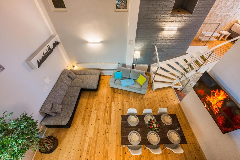 an overhead view of a living room with a couch and a fireplace at Exklusive und großzügige Wohnung 140 qm in Magdeburg TOP-Lage mit Kicker für bis zu 8 Personen in Magdeburg