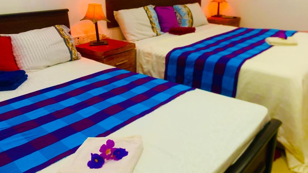 Postel nebo postele na pokoji v ubytování Aloe Home Stay