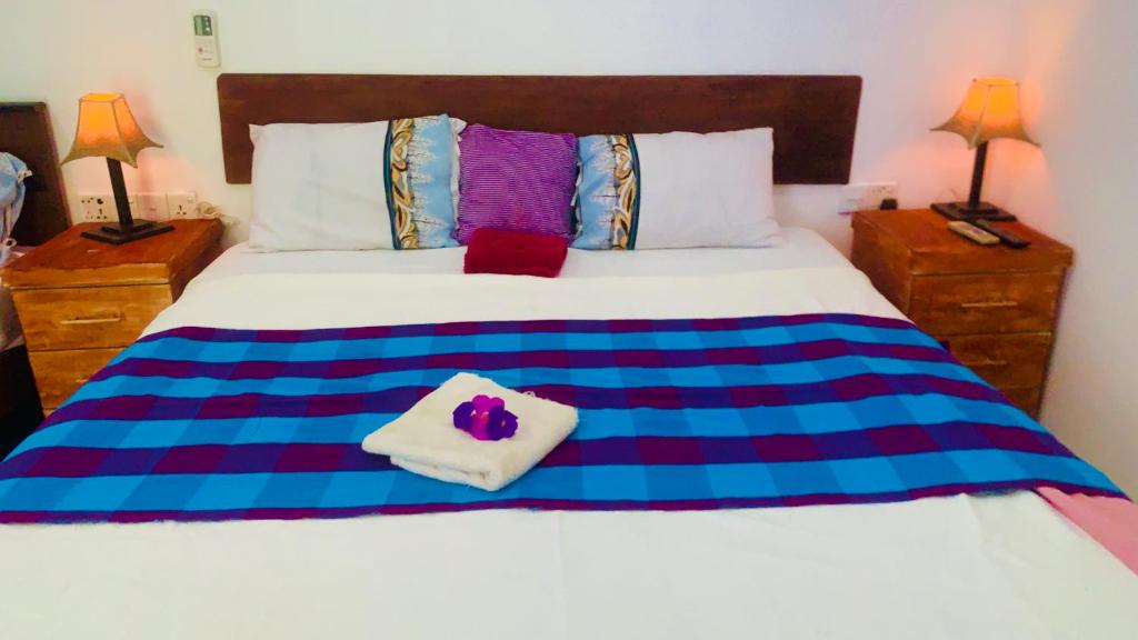 Postel nebo postele na pokoji v ubytování Aloe Home Stay