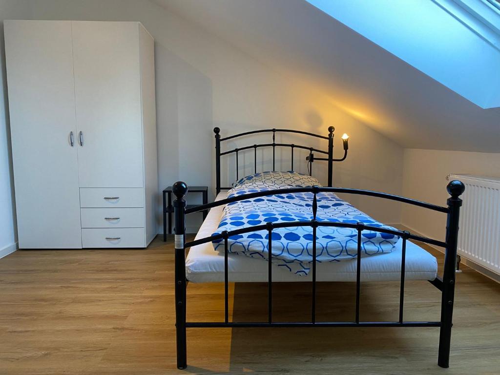 a bedroom with a black bed in a attic at Pelster´s Apartments in Diepholz