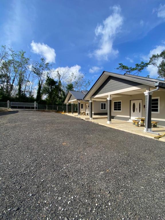 a house with a parking lot in front of it at D'Batu Hampar Homestay Chalok in Kampong Batu Hampar