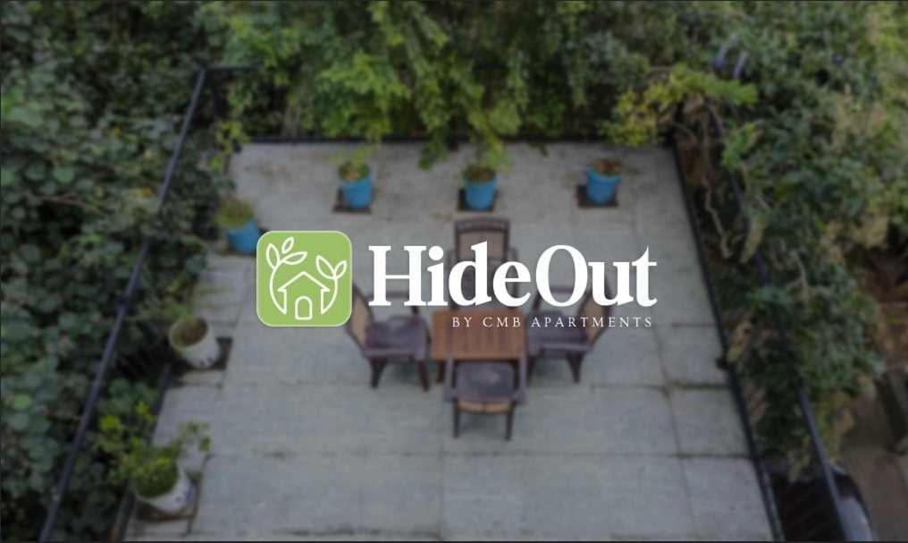 a view of a patio with chairs and a sign at HIDEOUT BY CMB APARTMENTS in Mount Lavinia