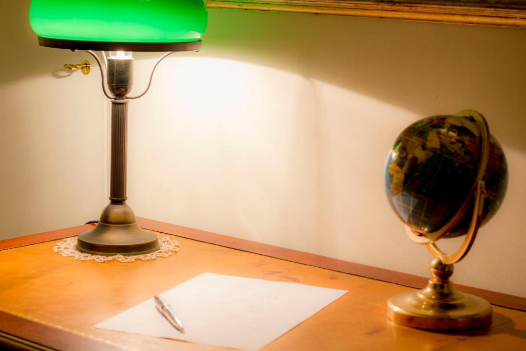 a desk with a lamp and a globe on it at Dimora Iride in Monopoli