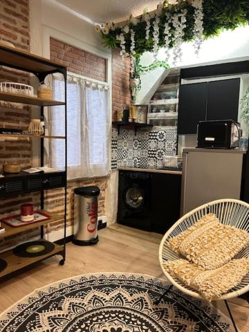 a living room with a refrigerator and a table at LA FACTORY in Perpignan