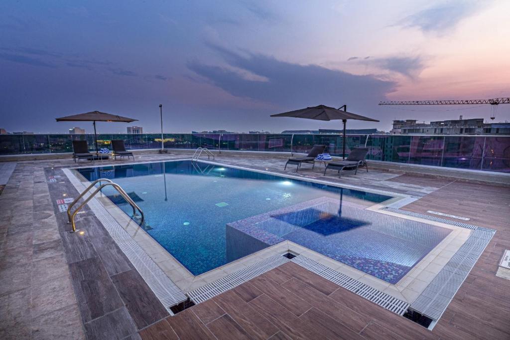 a swimming pool on top of a building at Green Park Hotel in Doha
