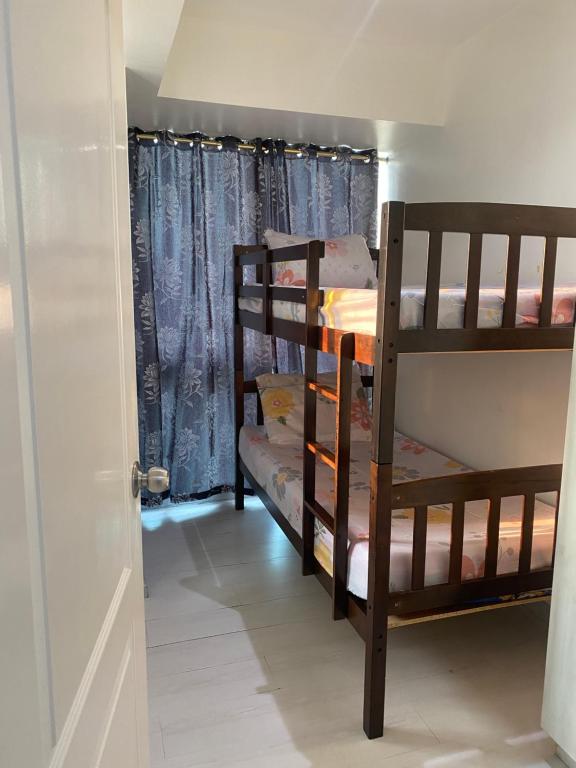 a hallway with two bunk beds in a room at Azure City 2 bedrooms affordable price in Manila