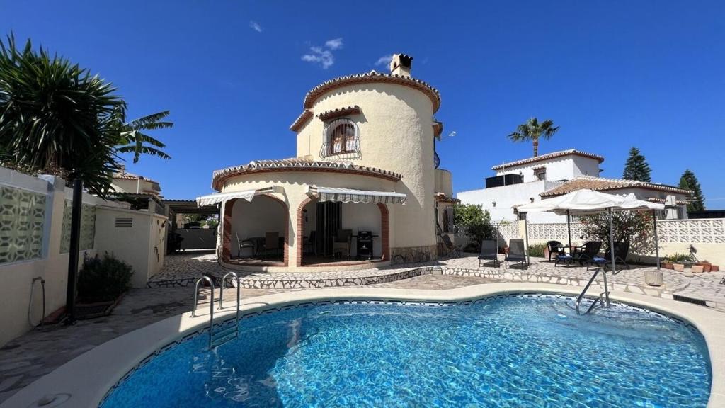 a house with a swimming pool in front of a building at Villa al Mar, Els Poblets, Top Lage und Ausstattung, Pool, WIFI, eigener überdachter Parkplatz, Photovoltaik-Anlage nah am Strand 500m in Miraflor