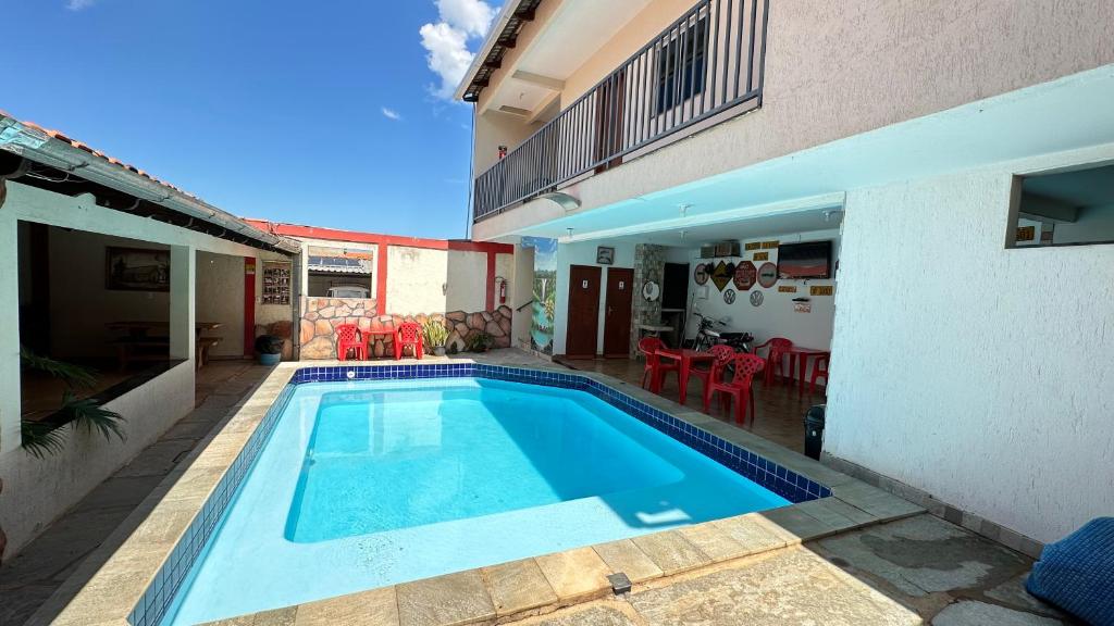 a swimming pool in the backyard of a house at Pousada Caminho das Cachoeiras Pirenopolis in Pirenópolis