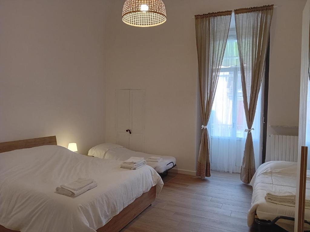 a bedroom with two beds and a window at La casetta - casa vacanze in Bisceglie