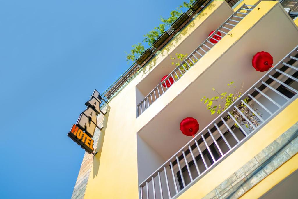 a building with red balls on the balconies at La An Old Town Hotel in Hoi An