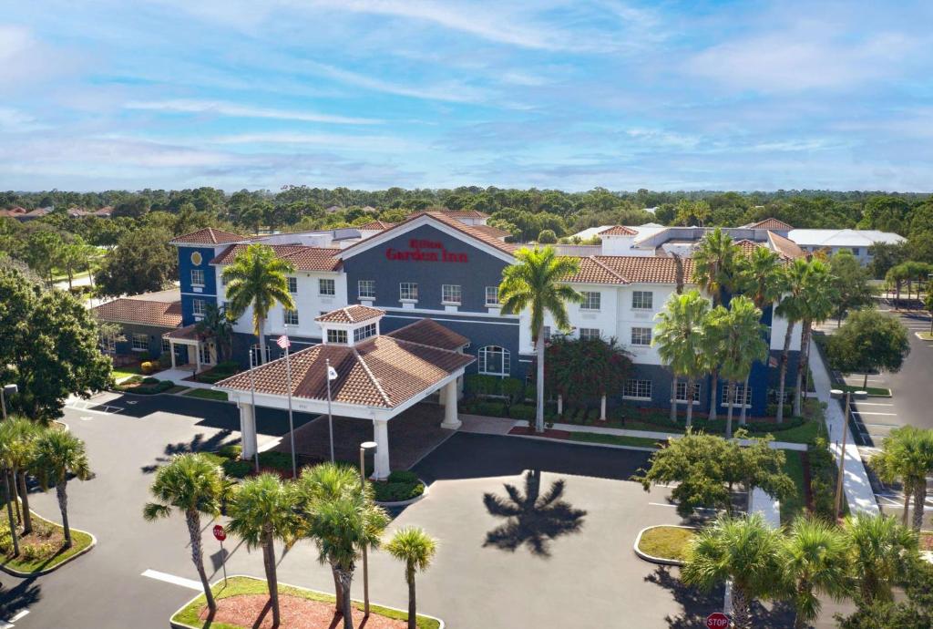 an aerial view of a hotel with palm trees at Hilton Garden Inn at PGA Village/Port St. Lucie in Port Saint Lucie