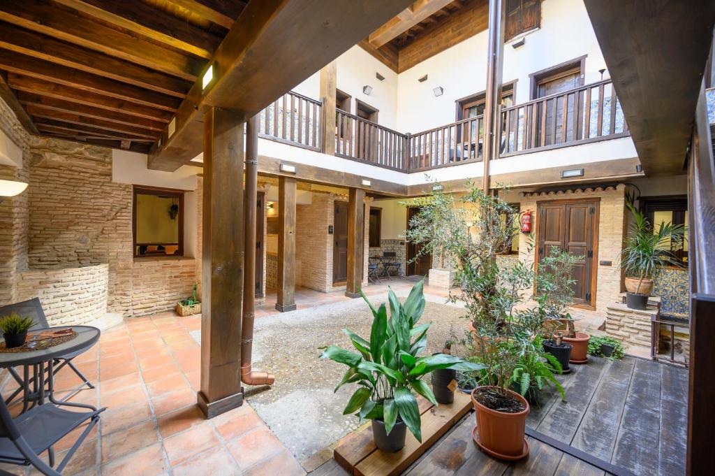 an indoor courtyard with potted plants in a building at El Patio de Toledo in Toledo