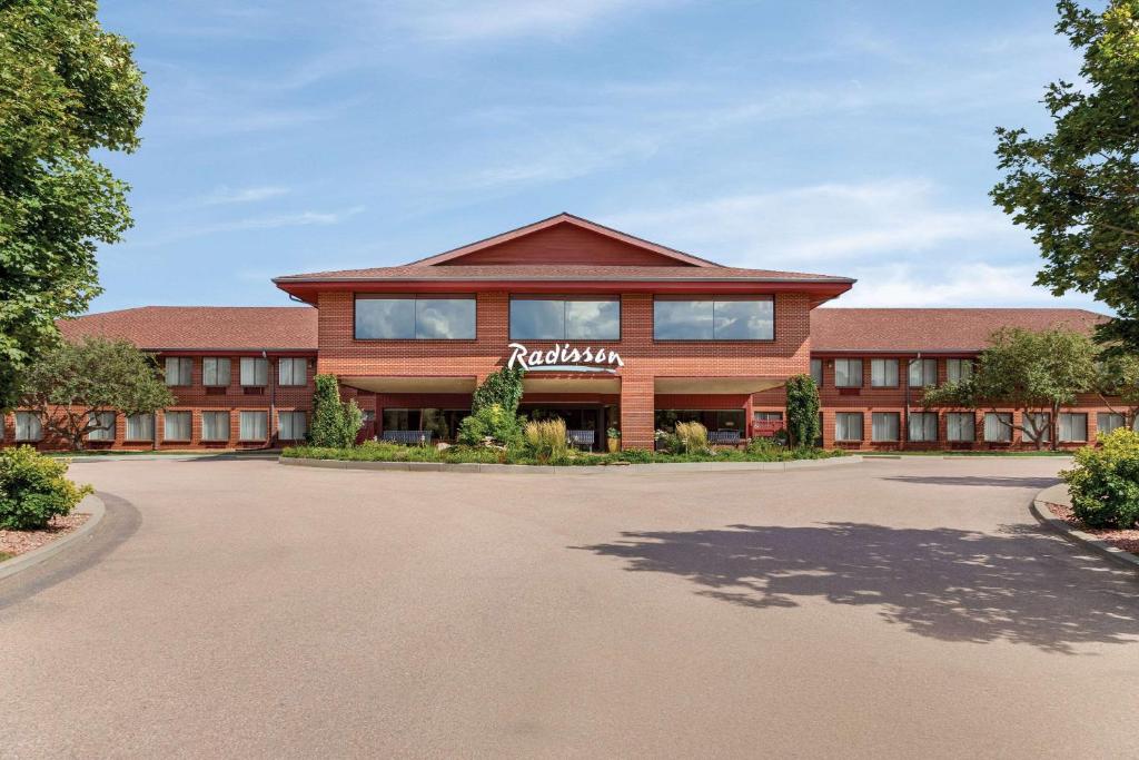 a building with a sign on the front of it at Radisson Hotel Colorado Springs Airport in Colorado Springs