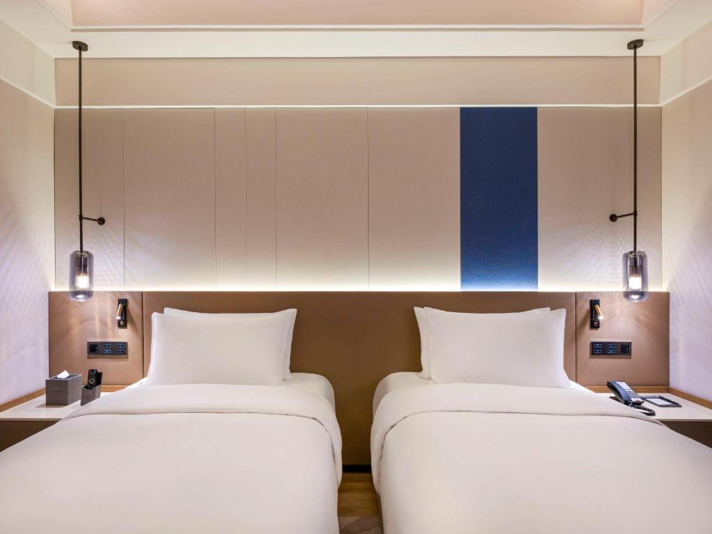 Postel nebo postele na pokoji v ubytování Novotel Shanghai JingAn