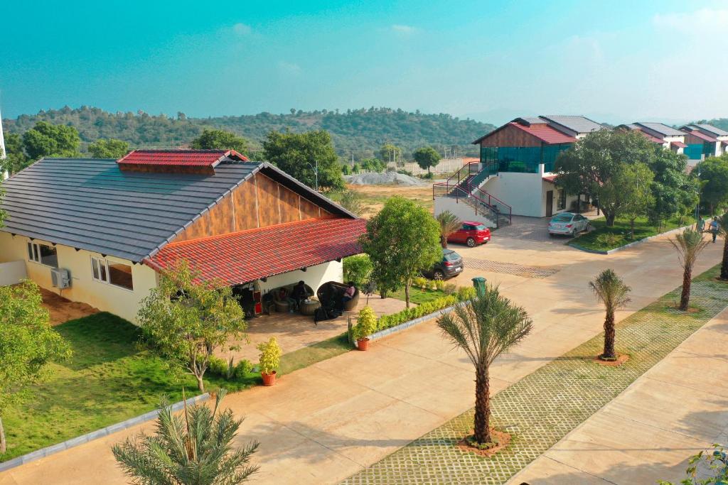 an aerial view of a house with a parking lot at Lake Valley Resort and Spa Tirupati in Tirupati