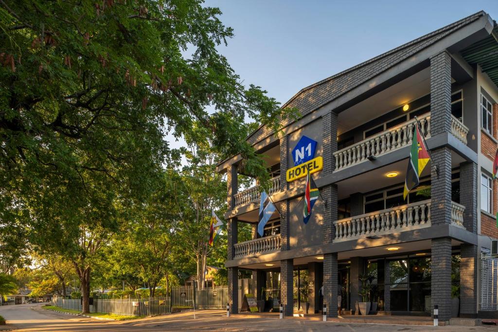 a building with a sign on the side of it at N1 Hotel & Campsite Victoria Falls in Victoria Falls