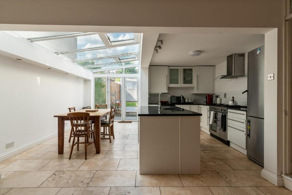 a kitchen with a table and a dining room at GuestReady - A Bohemian Home in Bath in Bath