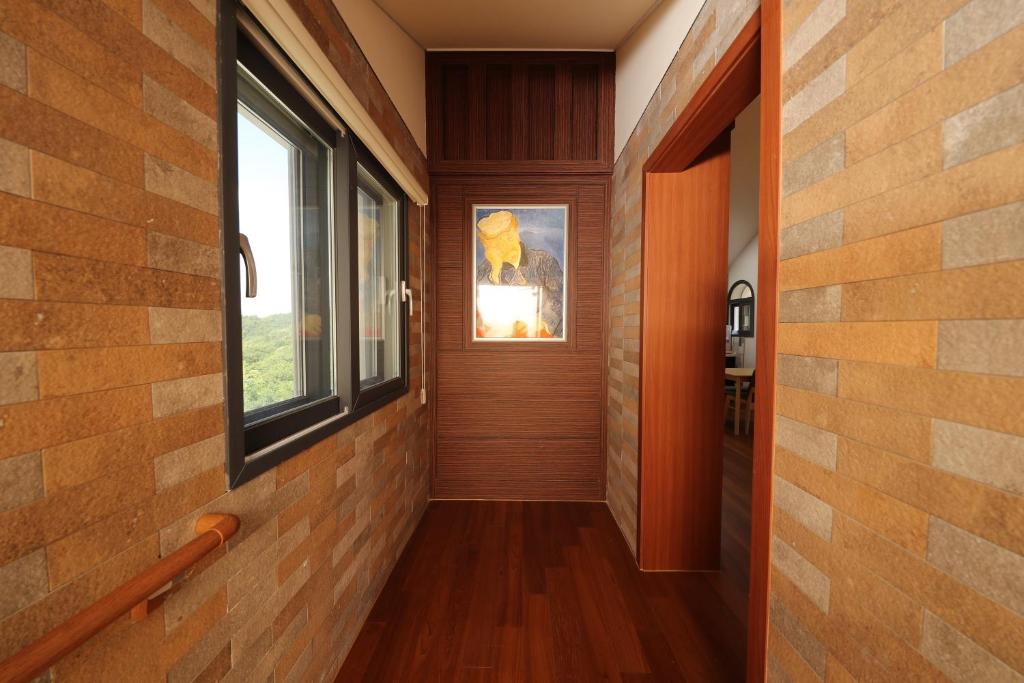 a hallway of a house with a window at Park Art Villas in Buyeo