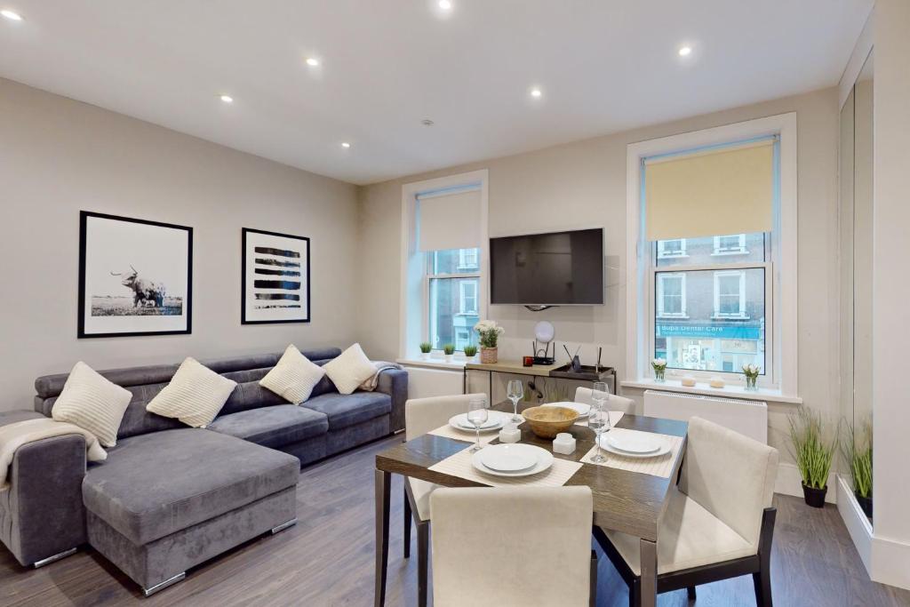 a living room with a couch and a table at Park Lane Apartments Marylebone in London
