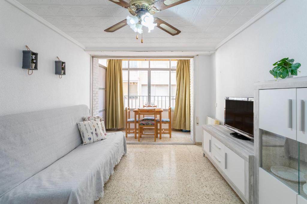 a living room with a couch and a television at Sunflower Pasaje in Santa Pola