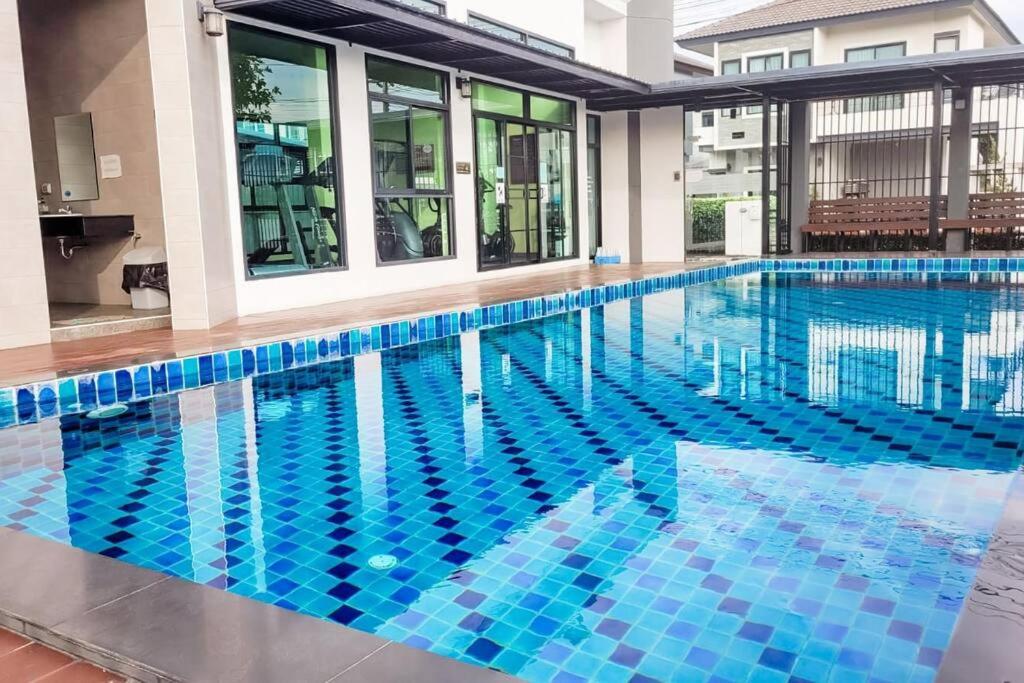 a swimming pool in a building with blue tiles at Simple & Cozy Home in prime location. Chiang Mai in Chiang Mai
