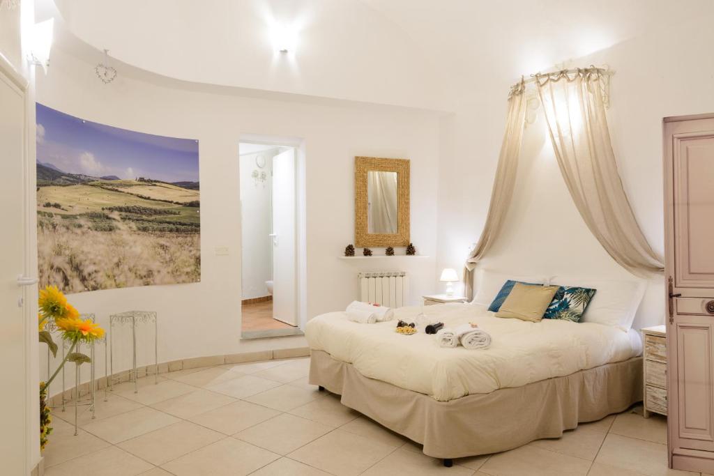 a bedroom with a large bed and a painting on the wall at Casa Vezzosa in Siena