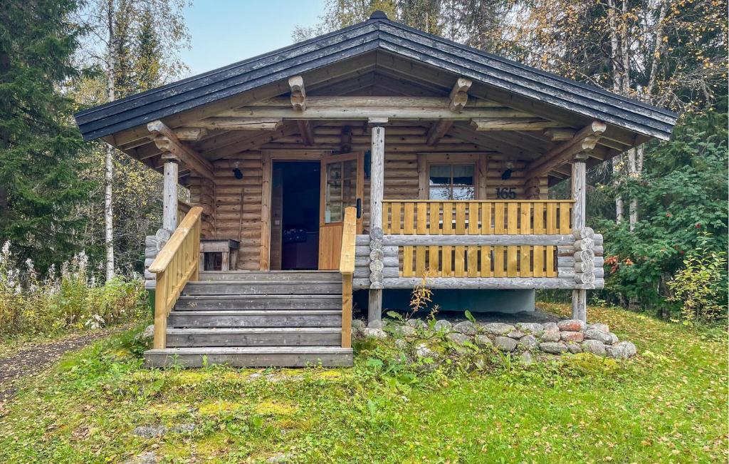 a wooden cabin with stairs and a porch at Beautiful Home In Fllinge With 1 Bedrooms in Vallrun