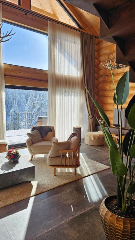a living room with a couch and a chair at Rtanj Kopaonik Eco Resort & Spa in Kopaonik