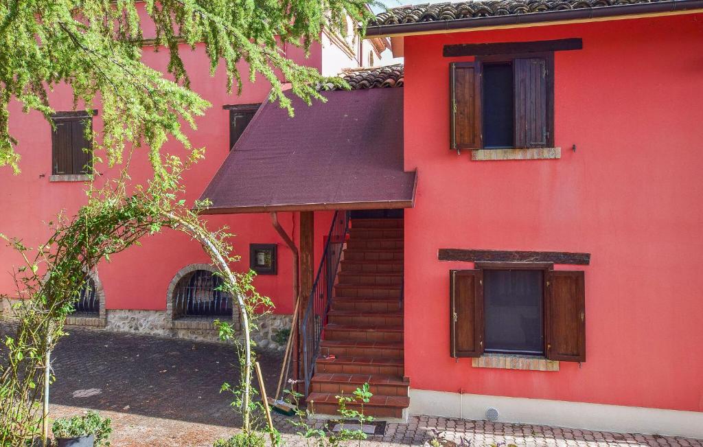 a red house with a staircase in front of it at Nice Home In Bellante With Kitchen in Bellante