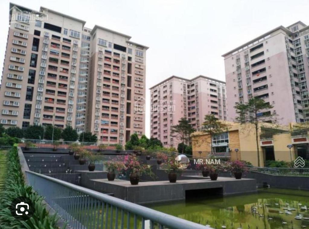a group of tall buildings in a city with a pond at Căn hộ 80m, 2 ngủ 2 vệ sinh-2 bedrooms apartment in Trương Lâm
