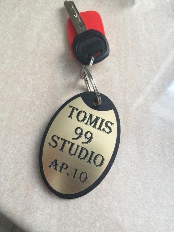 a key chain with the words tombs studio at Tomis 99 Apart in Constanţa