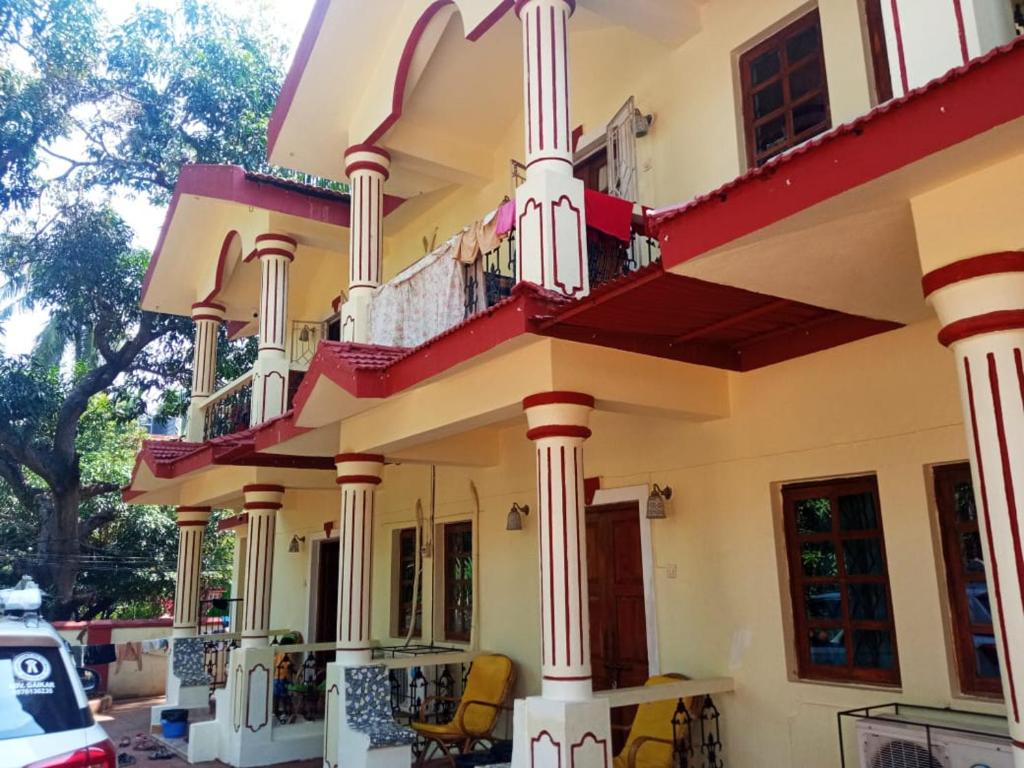 a house with columns and a balcony at R mansion in Calangute
